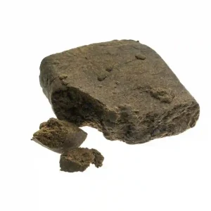 Close-up of premium 00 Hash (Zero Zero Moroccan Hash) with soft golden-brown texture and oily surface.